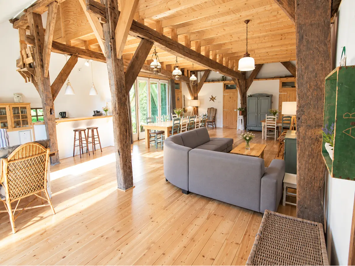 Sfeervolle woonkamer met gezellige zitjes Sfeervolle woonkamer voor de hele familie met eeuwenoude balken constructie